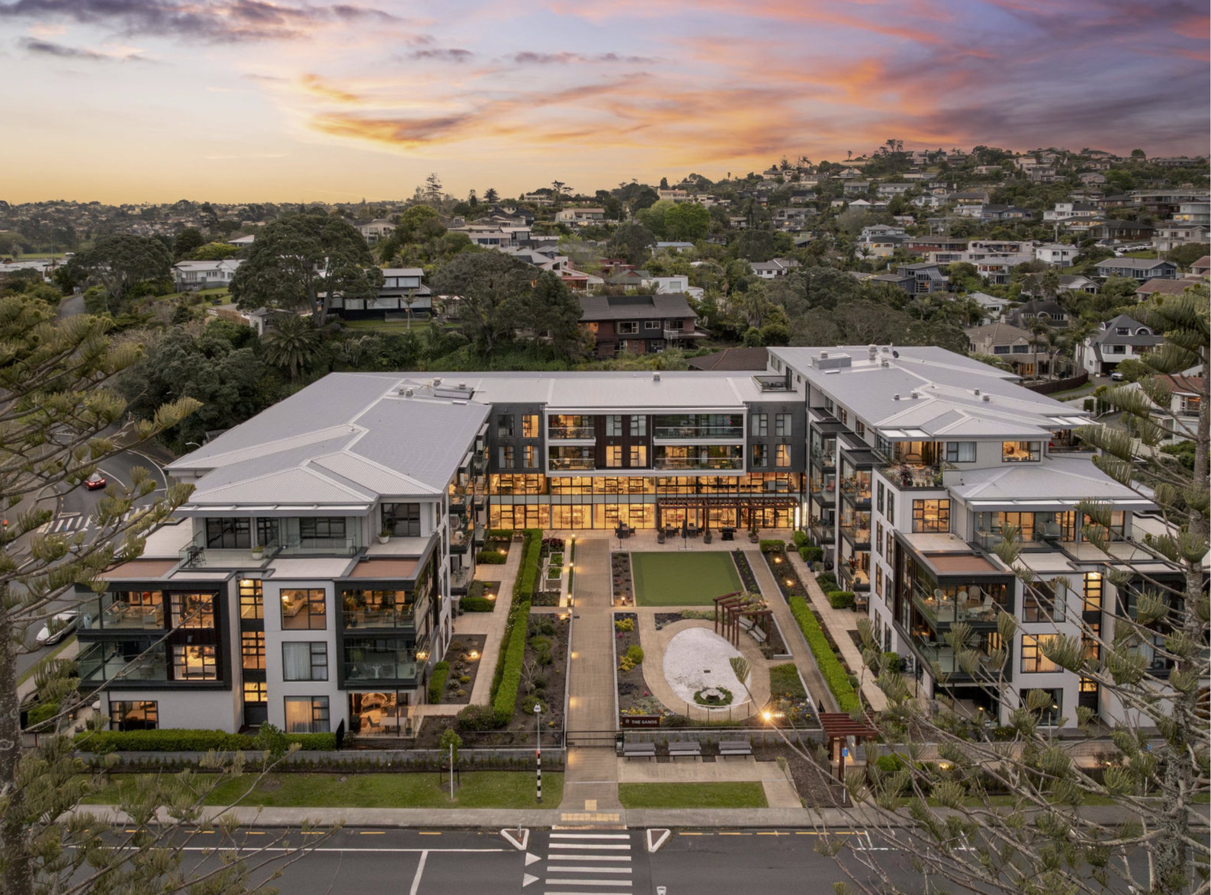Aerial view of a retirement village and its landscaped central gardens at dusk