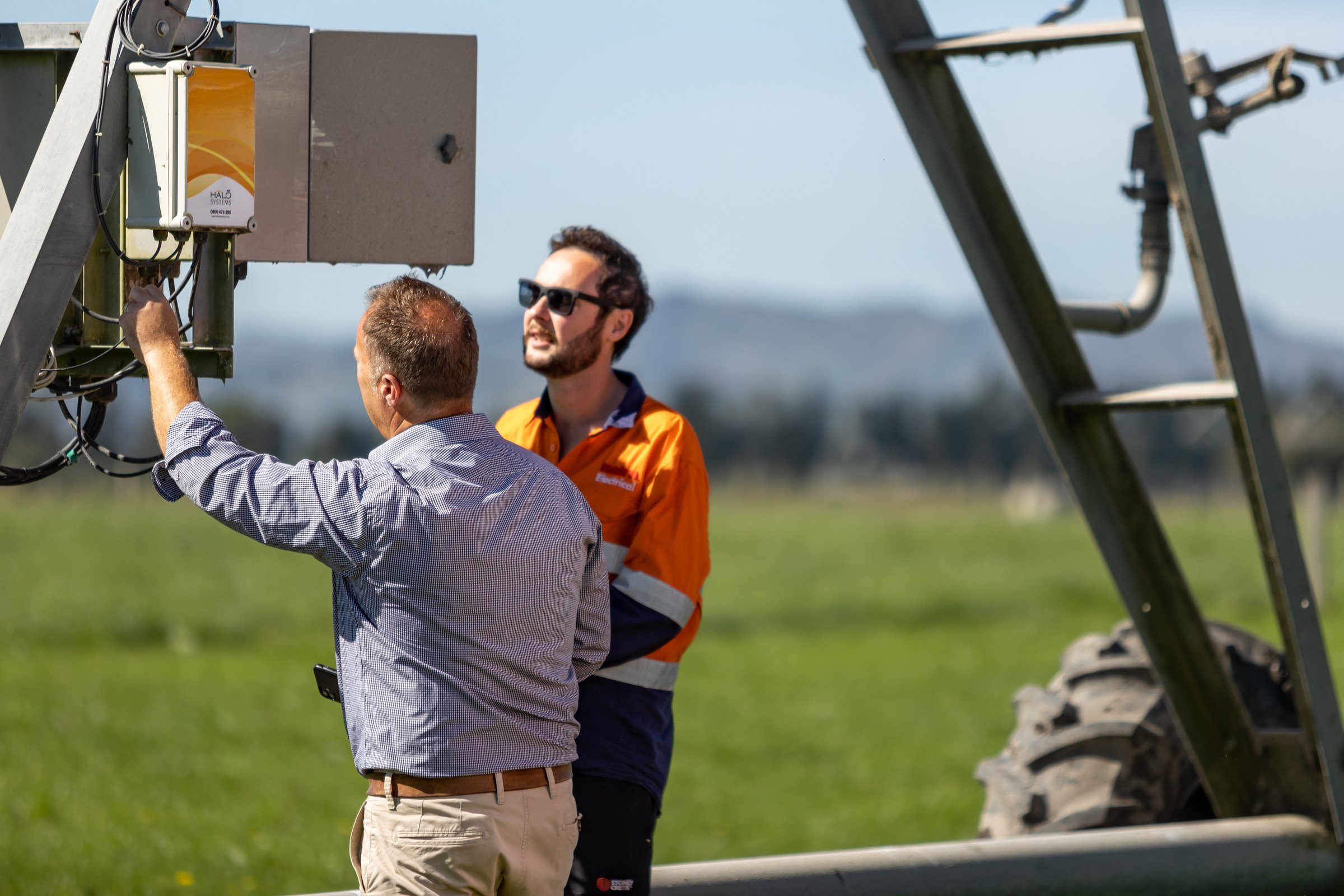 Two men inspecting a Halo irrigation system on a Canterbury farm