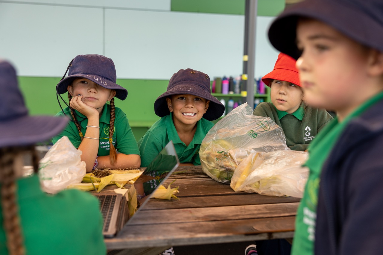 Pareawa Banks Avenue School students working on a project on the grass