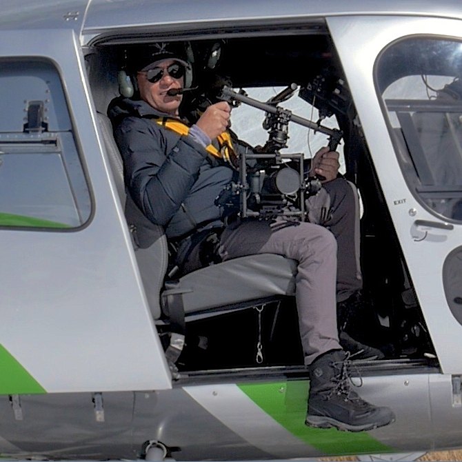 Wayne Cook filming with a stabilised camera rig from a helicopter